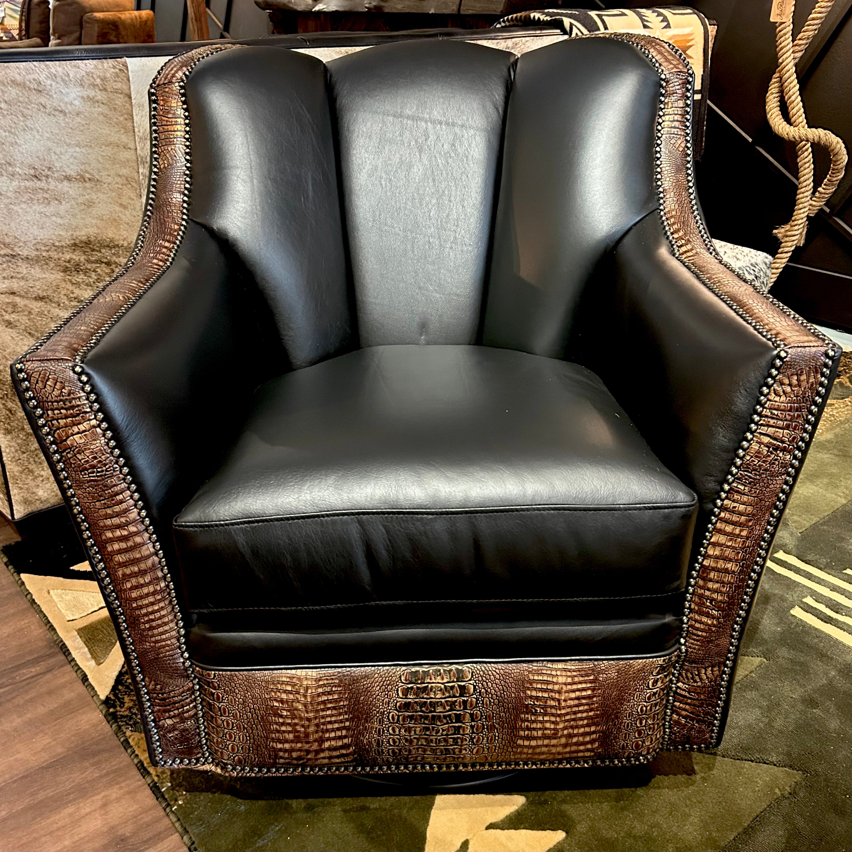 Black leather swivel glider armchair with embossed crocodile accents and nailheads.