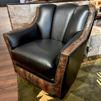 Black leather swivel glider armchair with embossed crocodile accents and nailheads.