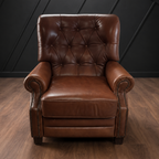 Brown leather armchair against a black paneled wall.