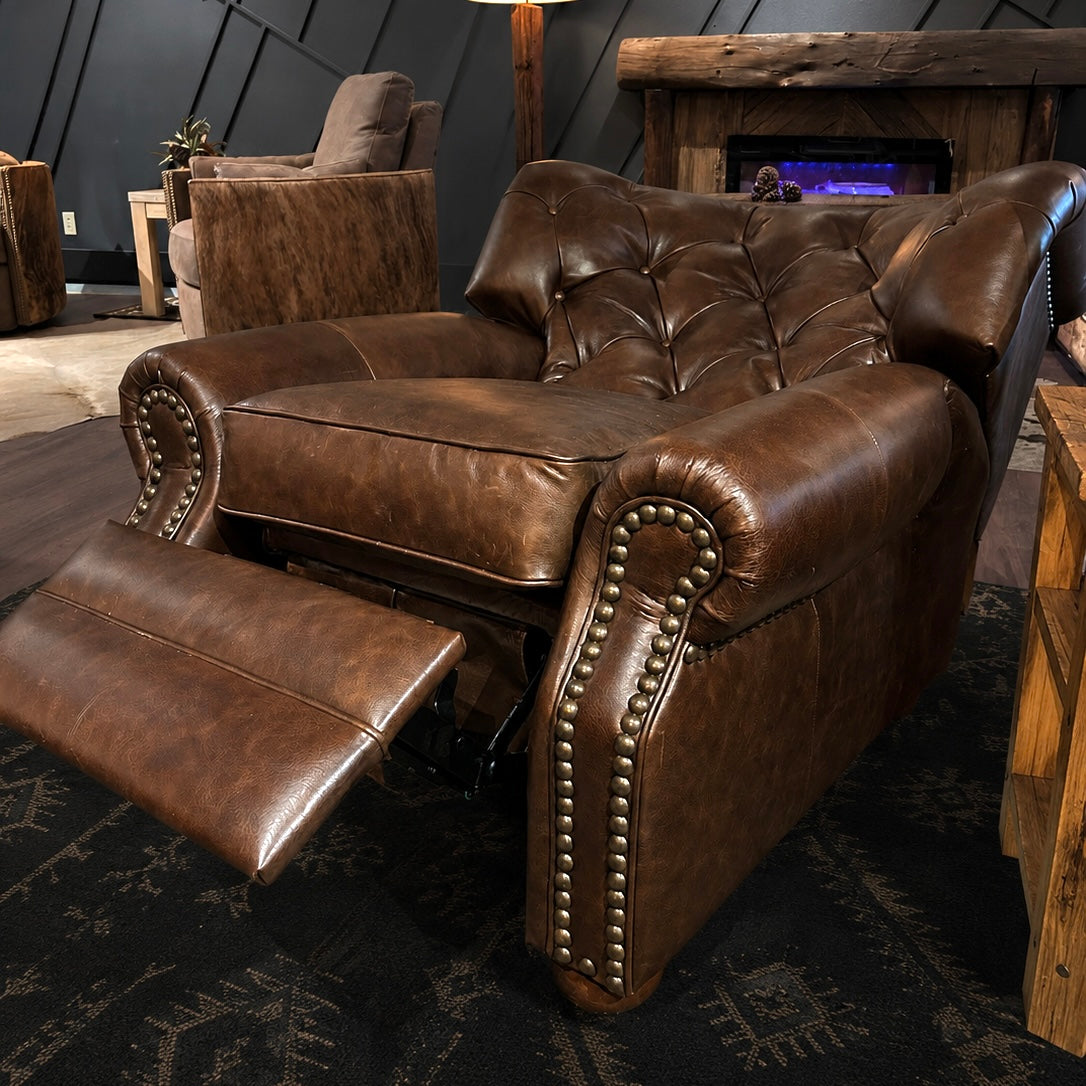 Brown leather recliner in a cozy living room setting with a fireplace.