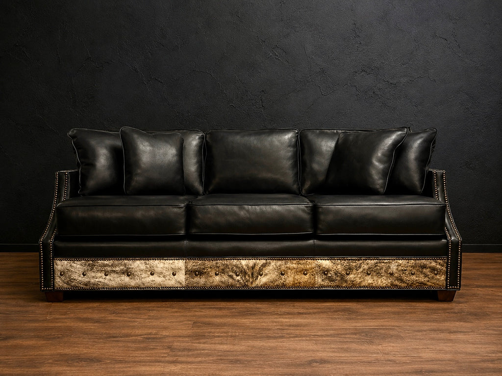 Black sofa with cowhide and nialhead accents