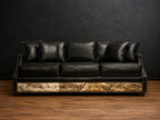 Black sofa with cowhide and nialhead accents