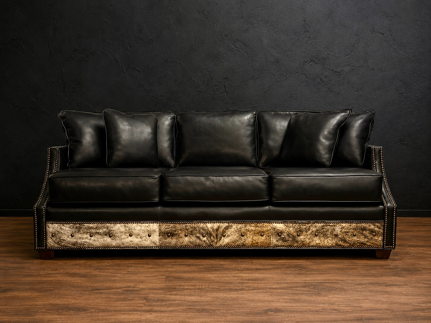Black sofa with cowhide and nialhead accents