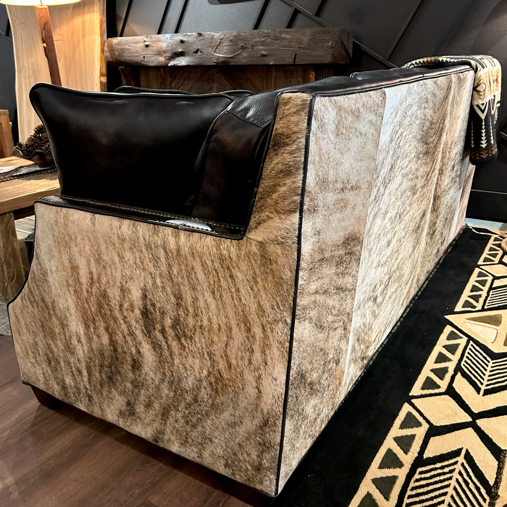 Sofa with brindle cowhide back.