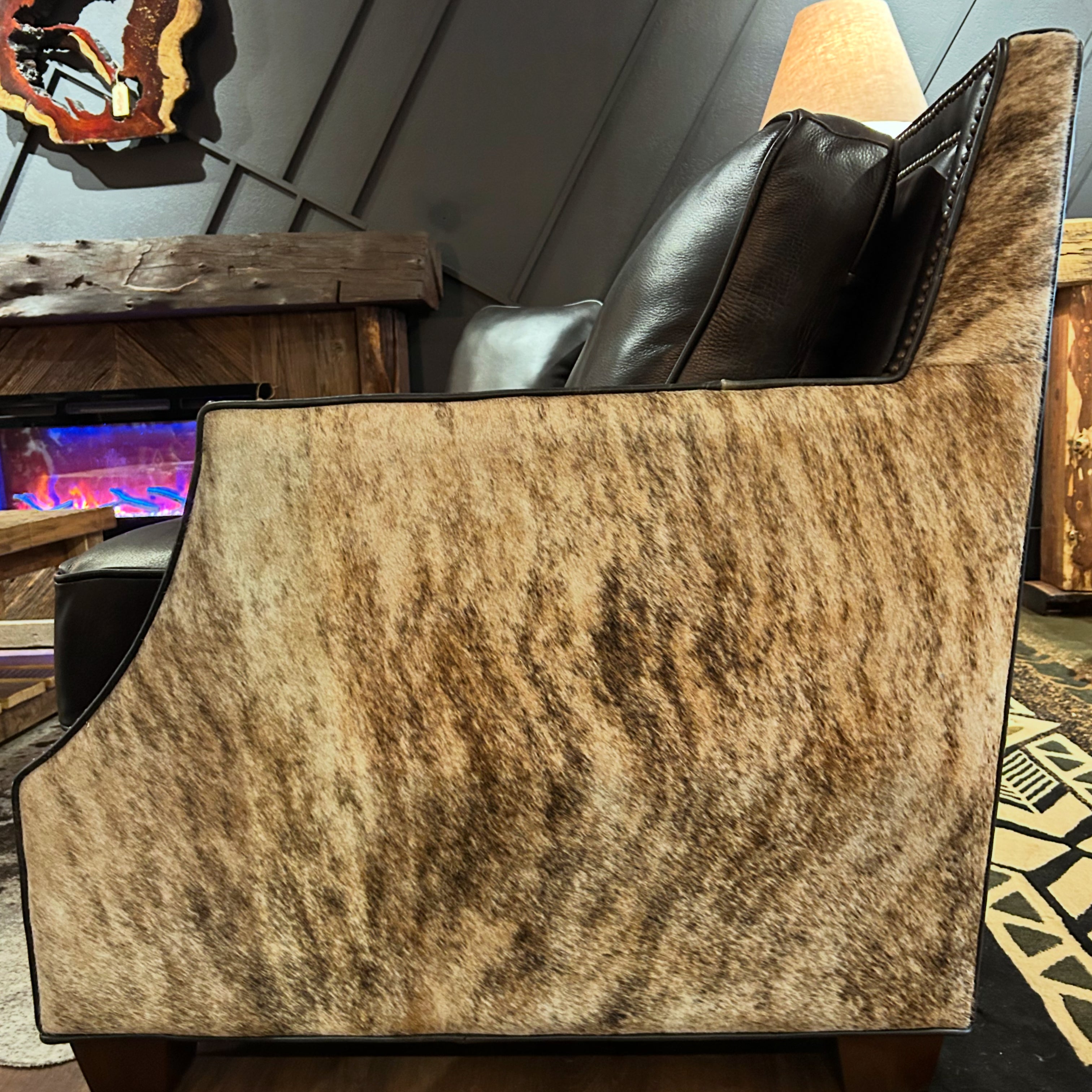 Black Sofa with brindle cowhide sides and back.