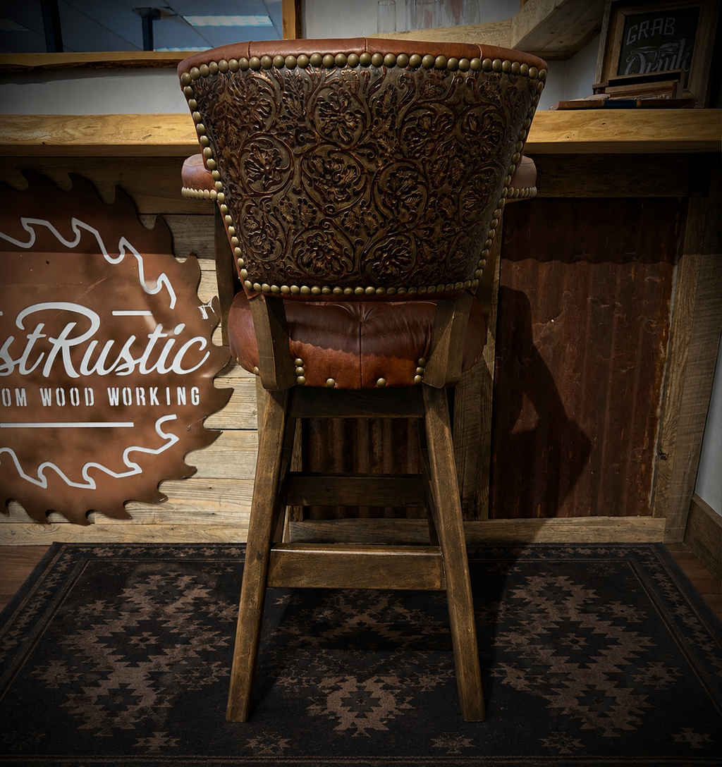 Brown leather barstool with button tufting and cowboy tooled leather.