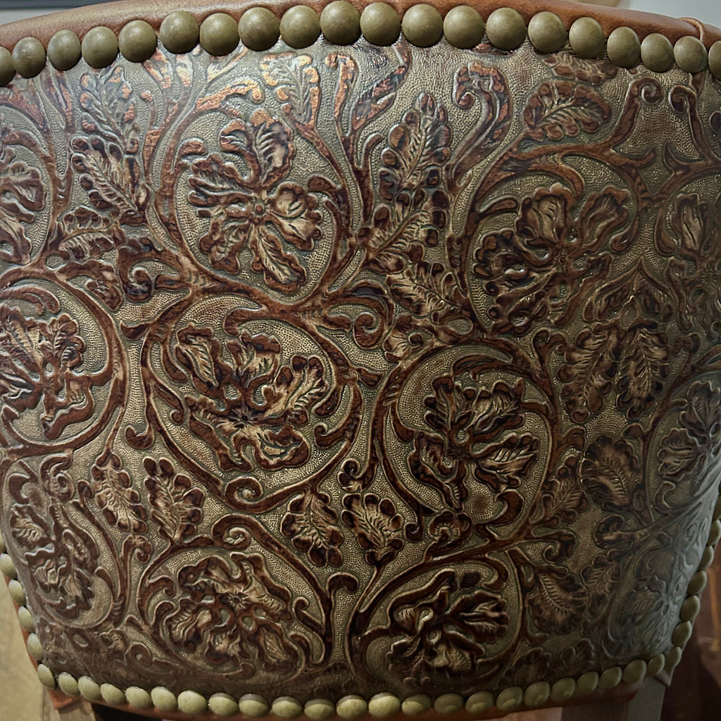 Brown leather barstool with button tufting and cowboy tooled leather.