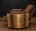 A luxury recliner chair featuring a brown leather back and seat with a curved front upholstered in natural axis hair-on-hide, set against a dark paneled wall and wood floor.