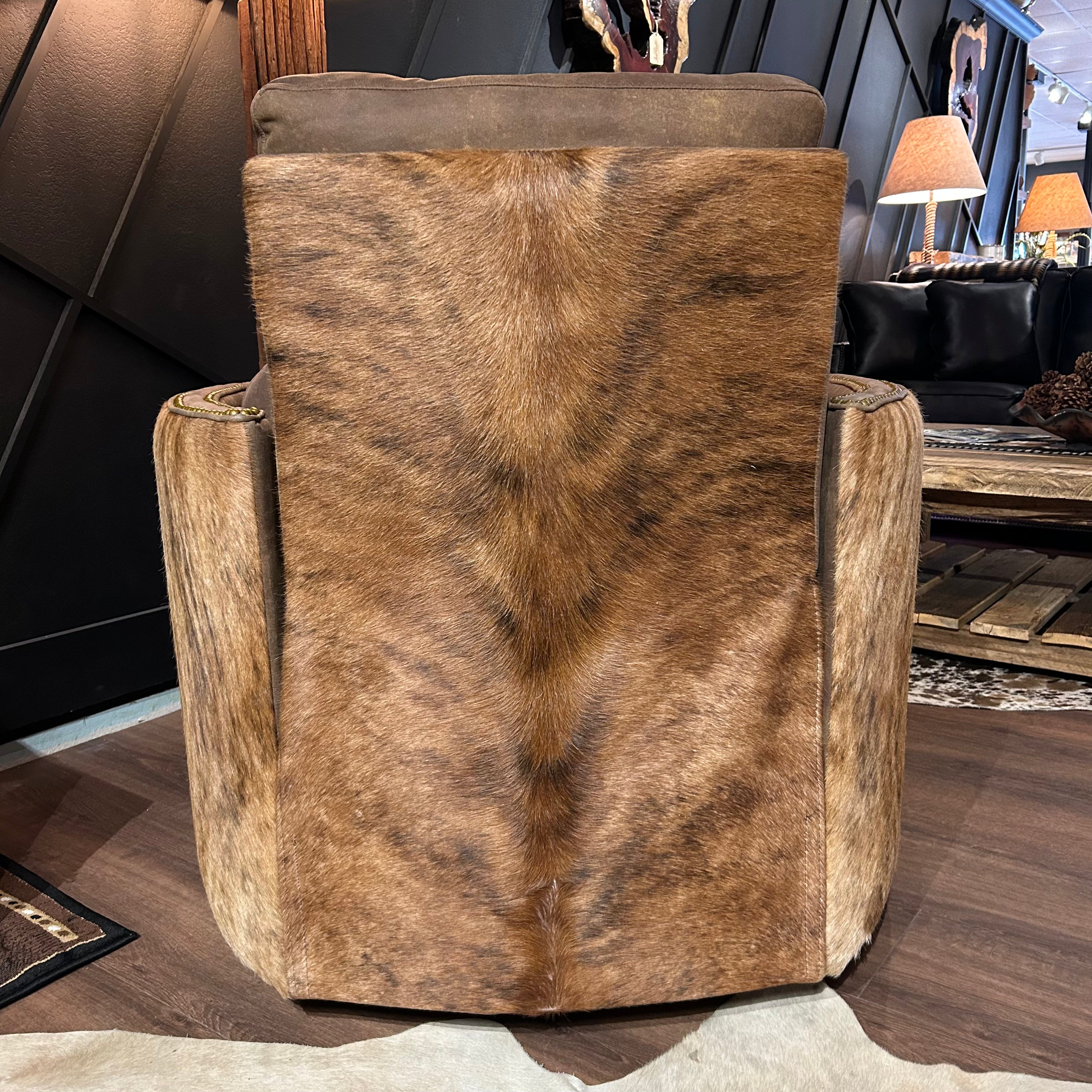 Brown leather recliner with cowhide arms and back.