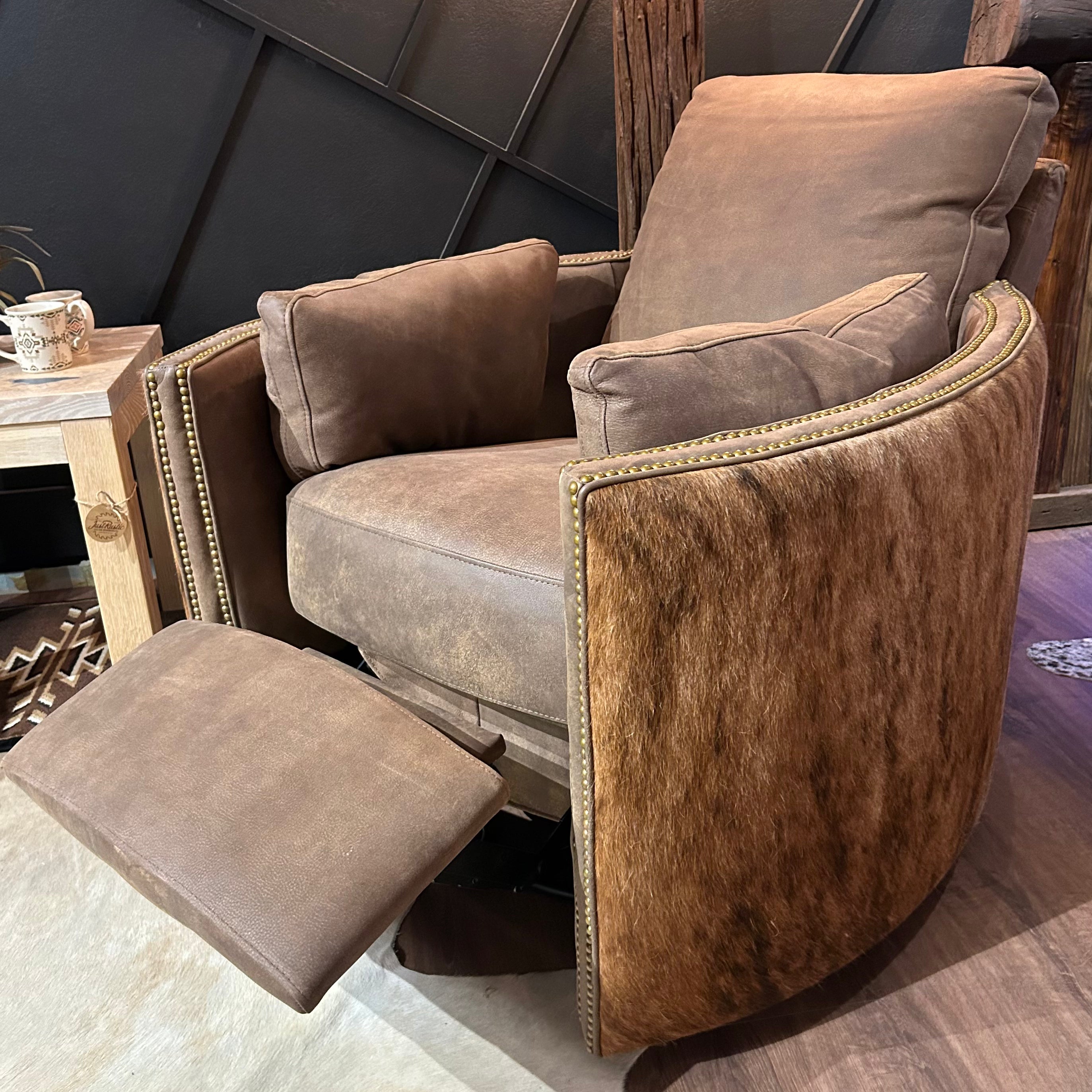 Brown leather recliner with cowhide arms and back.