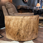 Brown leather recliner with cowhide arms and back.