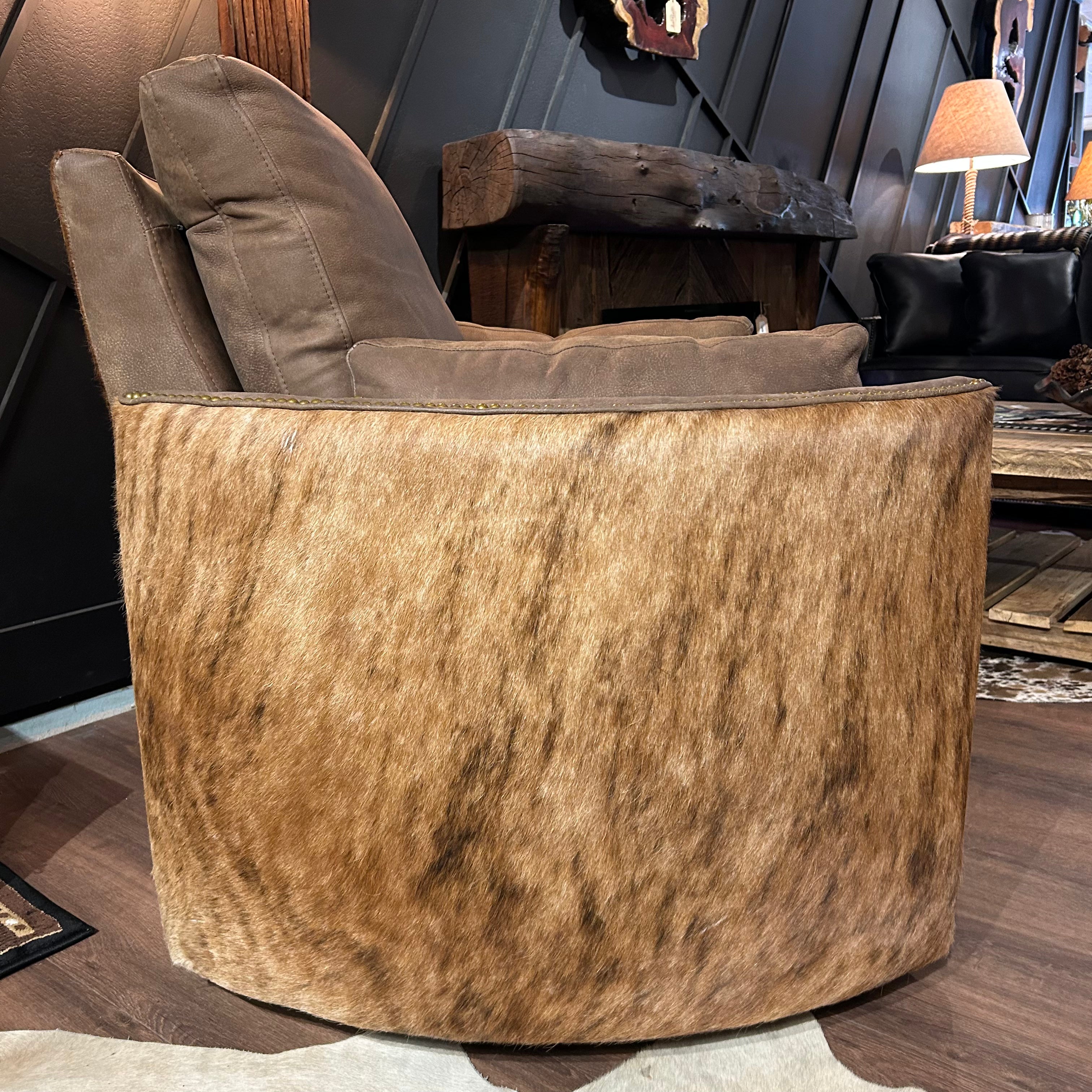 Brown leather recliner with cowhide arms and back.