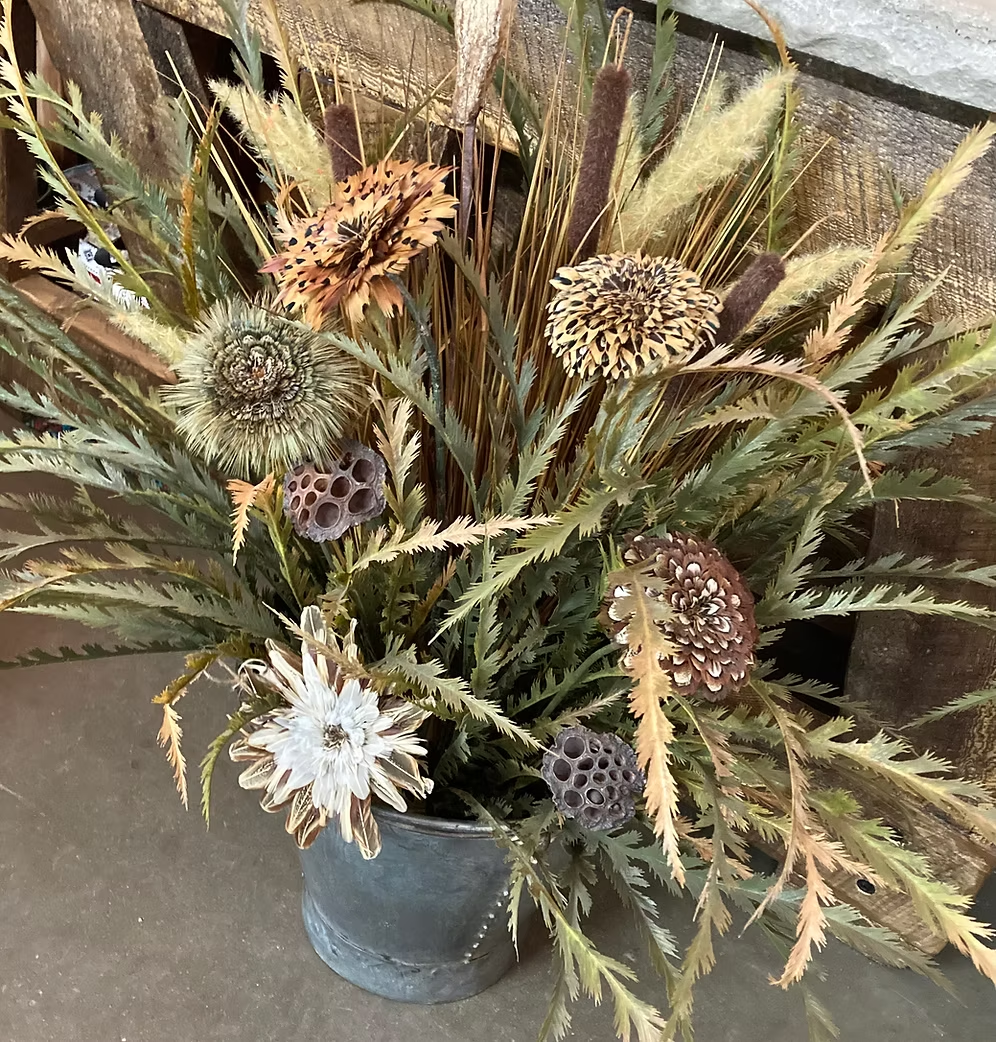 Angled view of Oversized Bucket Wowie feather flower arrangement