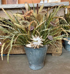 Oversized Bucket Wowie arrangement with five feather flowers and greenery in a rustic bucket