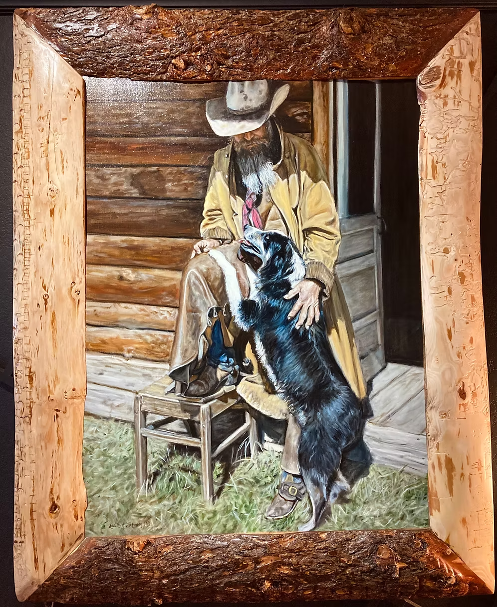My Buddy oil painting by Judith Dickinson showing a cowboy and dog in a rustic wood frame