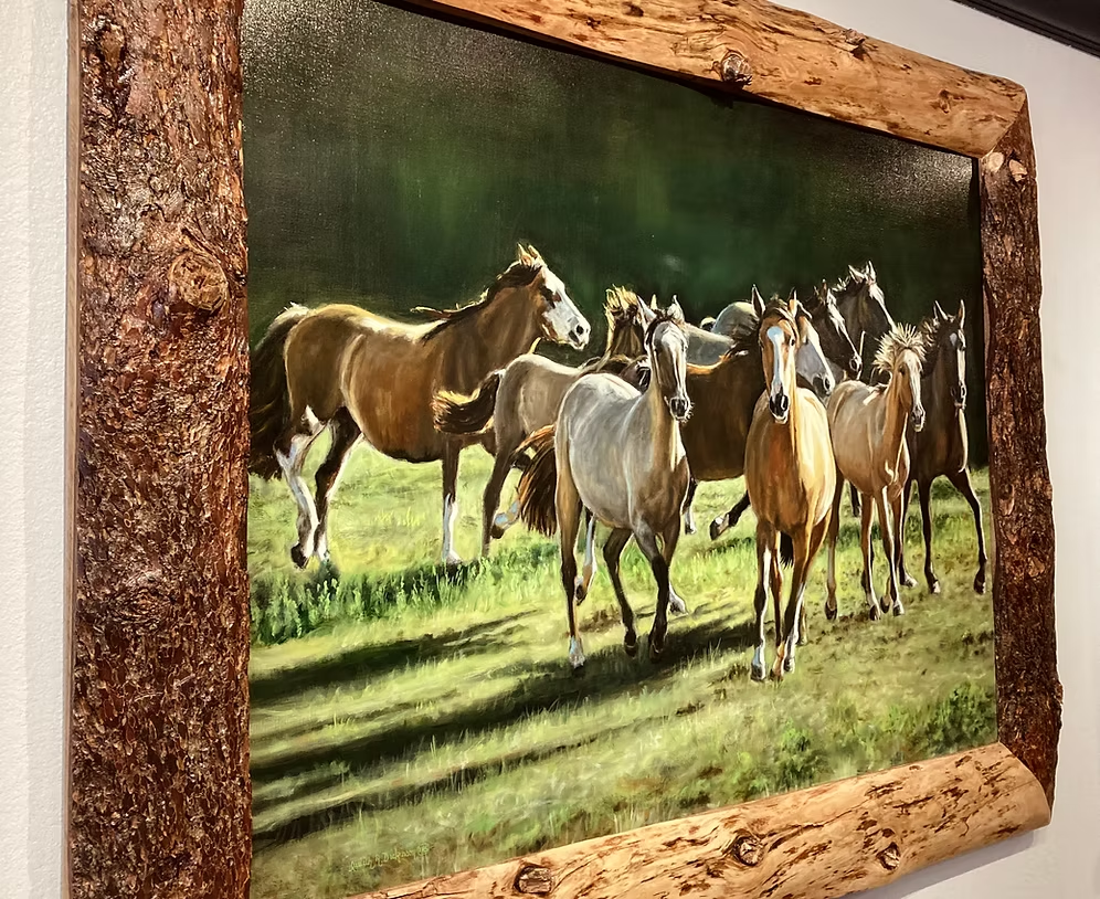Angled view of Stampede painting and its textured wood frame