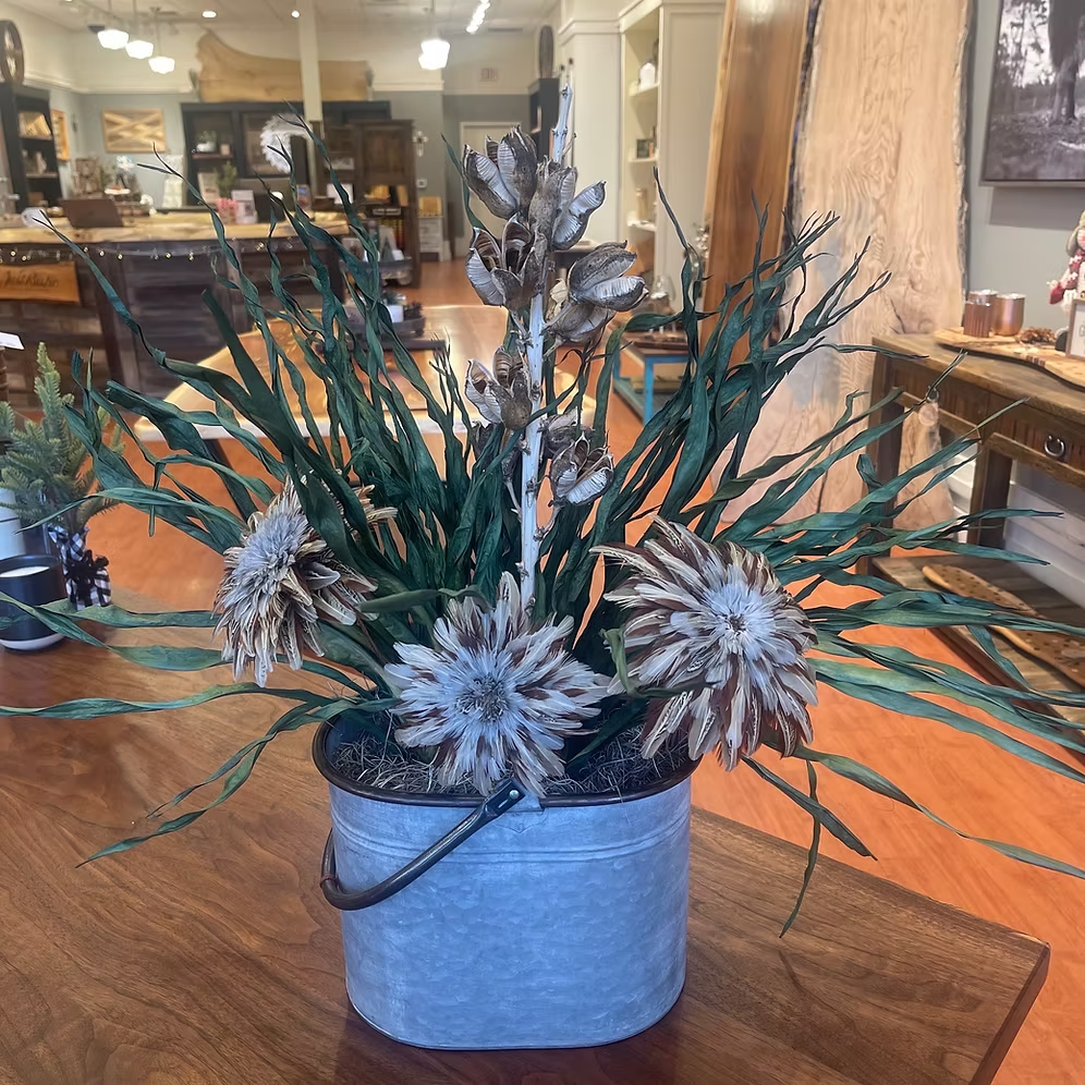 Tin Pail Arrangement with three feather wing flowers, yucca pods, and sweeping greenery