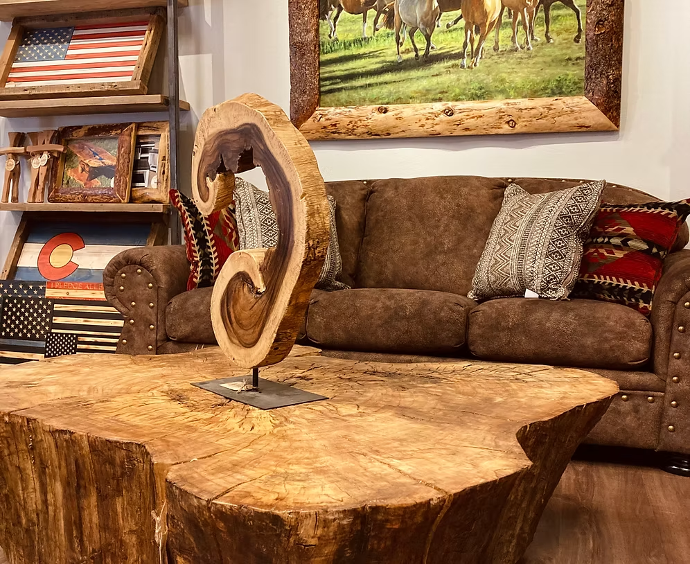 Stampede horse painting displayed above a leather sofa