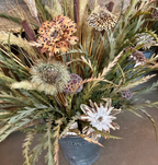 Detail of five oversized feather flowers and textured greenery in the Bucket Wowie arrangement